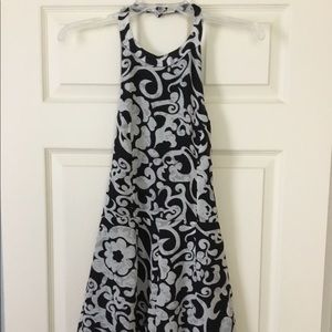 Black and cream colored halter, backless romper